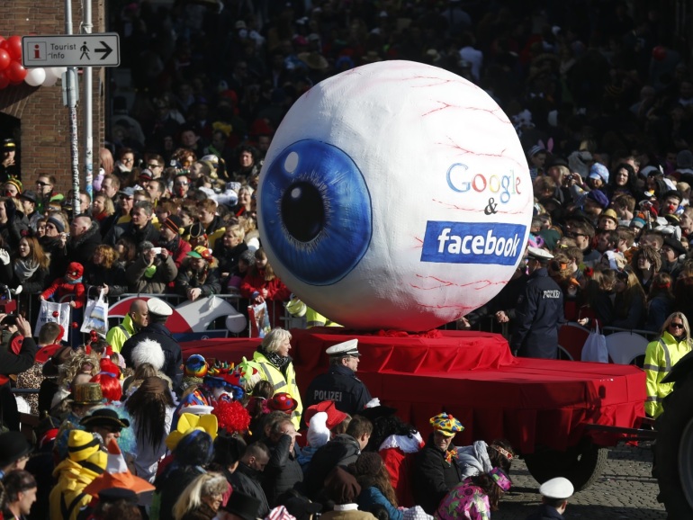 A carnival float with a papier-mache caricature representing Google and Facebook takes part in the traditional Rose Monday carnival parade in the western German city of Duesseldorf February 16, 2015. The Rose Monday parades in Cologne, Mainz and Duesseldorf are the highlight of the German street carnival season. REUTERS/Ina Fassbender (GERMANY - Tags: POLITICS SOCIETY)