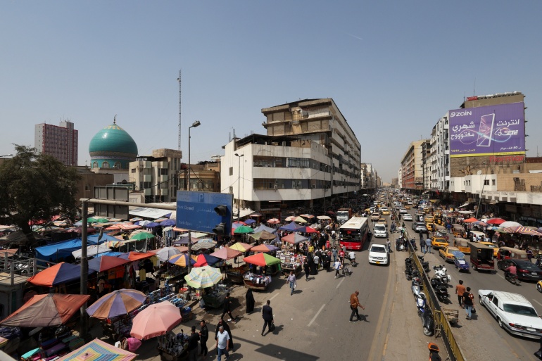 Residents shop at a wholesale market ahead of the holy fasting month of Ramadan in Baghdad