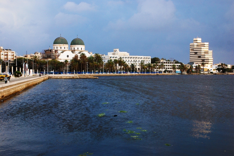 Look at the port of Benghazi. There is a lot of trash in the water. On the horizon is the only Christian church in Libya. Benghazi, Libya, April 6, 2011.