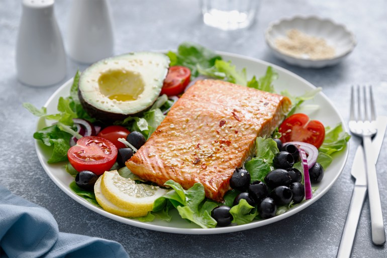 Grilled salmon fish fillet and fresh vegetable salad with tomato, red onion, black olives and avocado - stock photo Grilled salmon fish fillet and fresh vegetable salad with tomato, red onion, black olives and avocado