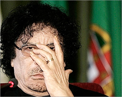 REUTERS/ Libya's President Muammar Gaddafi adjusts his glasses during his speech, before the EU-Africa summit, at Lisbon's University, December 7, 2007. Lybian leader Gaddafi, visiting Europe after decades of ostracism by the West, on Friday condemned the "dictatorship" of the U.N. Security Council which he blamed for terrorism and word tensions. REUTERS/Nacho Doce (PORTUGAL)