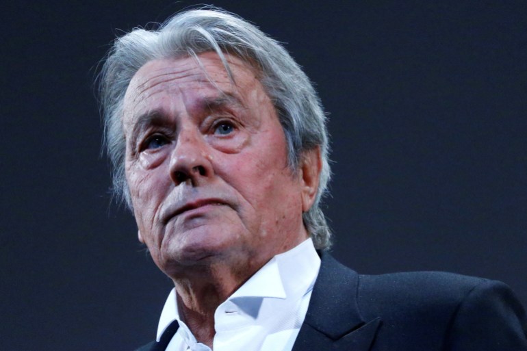 FILE PHOTO: Actor Alain Delon salutes on stage during a tribute for his career before the screening of the restored print of the film "Plein Soleil" by Rene Clement during the 66th Cannes Film Festival in Cannes May 25, 2013. REUTERS/Yves Herman/File Photo