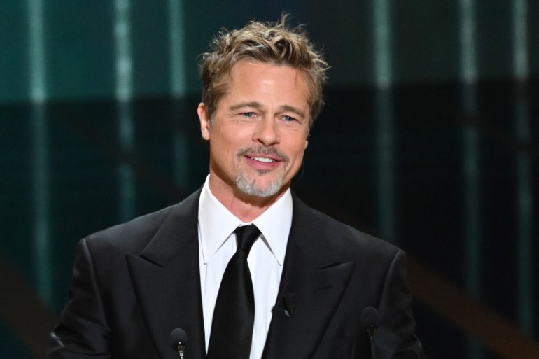 GettyImages-1469289926 Ceremony - 48th Cesar Film Awards At L'Olympia In Paris PARIS, FRANCE - FEBRUARY 24: Brad Pitt onstage while David Fincher receives the "Honorary César Award" during the 48th Cesar Film Awards at L'Olympia on February 24, 2023 in Paris, France. (Photo by Stephane Cardinale - Corbis/Corbis via Getty Images)