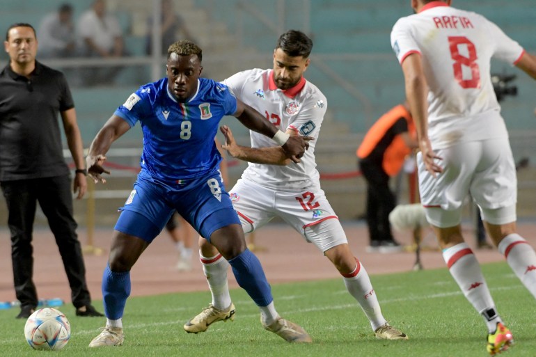 Equatorial Guinea center #08 Jannick Buyla (L) and Tunisia's defender #12 Hamza Mathlouthi (R) fight for the ball during the FIFA World Cup 2026, CAF Group H qualifier football match, between Tunisia and Equatorial Guinea at the Hammadi Agrebi Stadium, in Tunis on June 5, 2024. (Photo by Fethi Belaid / AFP)