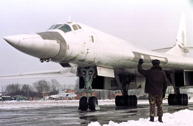 A ground crew member leads the Tupolev-160 "Blackjack" strategic bomber to a landing strip before the flight at a military airfield in Priluky, some 100 kms east of Kiev, February 21. Ukraine on Monday completed the transfer of eight Tupolev-160 and three Tupolev-95MS Bear bombers to Russia under a deal to help pay its multi-million-dollar energy debts by sending the last two bombers to a Russian airbase in Engels.