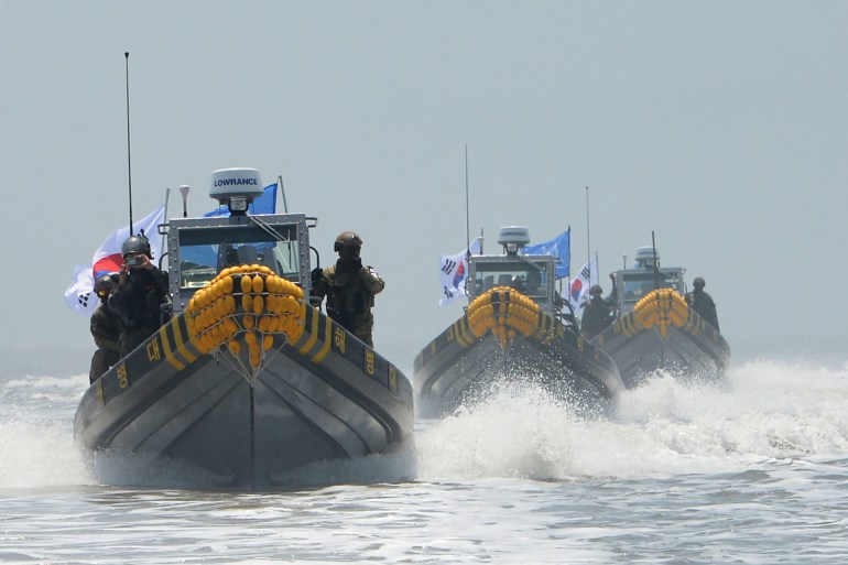 This photo released by South Korean Defence Ministry shows South Korean patrol boats conducting an operation to drive out illegal Chinese fishing boats from neutral waters close to the disputed sea border with North Korea on June 10, 2016. The patrol is the first military operation in the buffer zone -- an effective no-man's land at sea -- between the two Koreas since the area was drawn up at the end of the Korean War in 1953. (Photo by Handout / South Korean Defence Ministry / AFP)