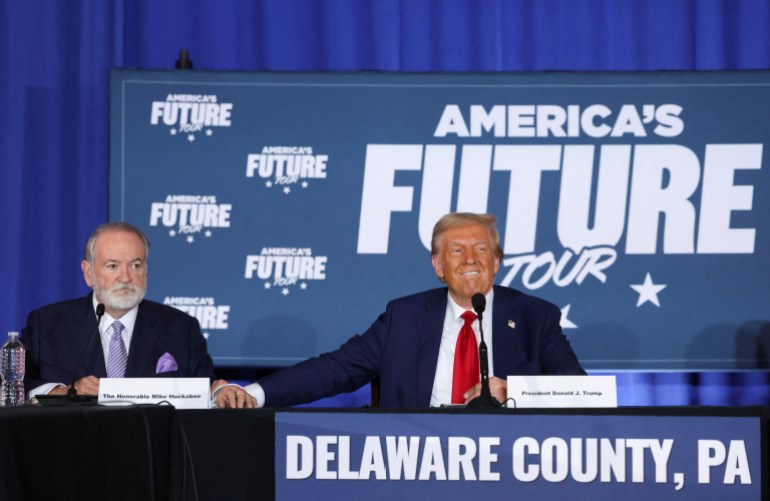 FILE PHOTO: Mike Huckabee looks on as Republican presidential nominee and former U.S. President Donald Trump reacts during a campaign event at the Drexelbrook Catering and Event Center, in Drexel Hill, Pennsylvania, U.S., October 29, 2024. REUTERS/Brendan McDermid/File Photo