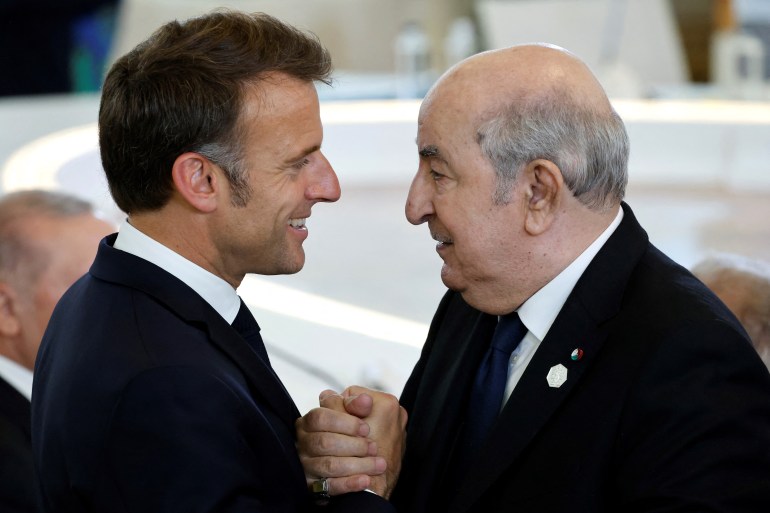 French President Emmanuel Macron (L) speaks with Algeria's President Abdelmadjid Tebboune (R) during a working session on Artificial Intelligence (AI), Energy, Africa-Mediterranean at the Borgo Egnazia resort during the G7 Summit in Savelletri near Bari, Italy, on June 14, 2024. (Photo by Ludovic MARIN / AFP)