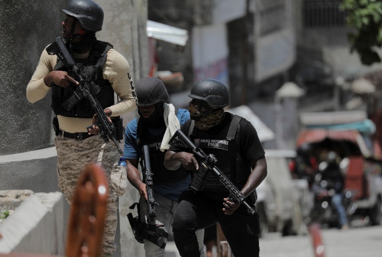 Police try to protect residents fleeing the neighbourhood after gangs took over Carrefour Feuilles, in Port-au-Prince, Haiti August 15, 2023. REUTERS/Ralph Tedy Erol