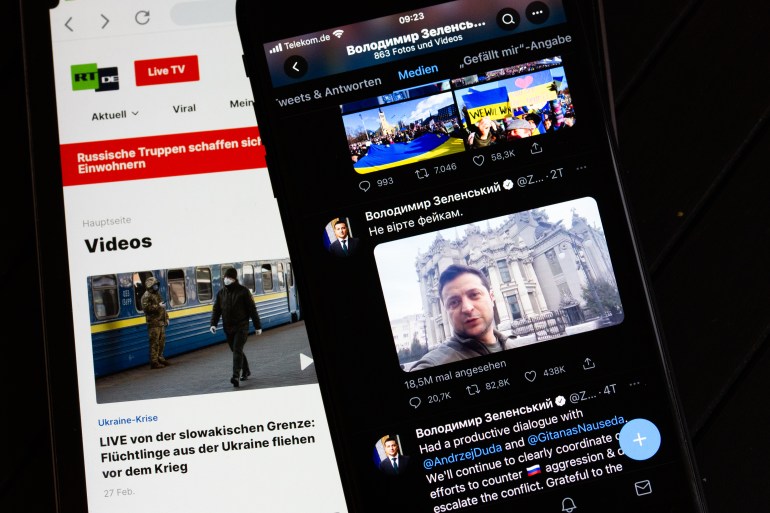 ILLUSTRATION - 28 February 2022, Berlin: On the screen of a tablet (l), the website of the Russian TV channel RT can be seen. On the right, the screen of a smartphone shows the official Twitter account of Ukrainian President Selenskyj. (to dpa "Russia and Ukraine fight for sovereignty of opinion in social media") Photo: Fernando Gutierrez-Juarez/dpa-Zentralbild/dpa (Photo by Fernando Gutierrez-Juarez/picture alliance via Getty Images)