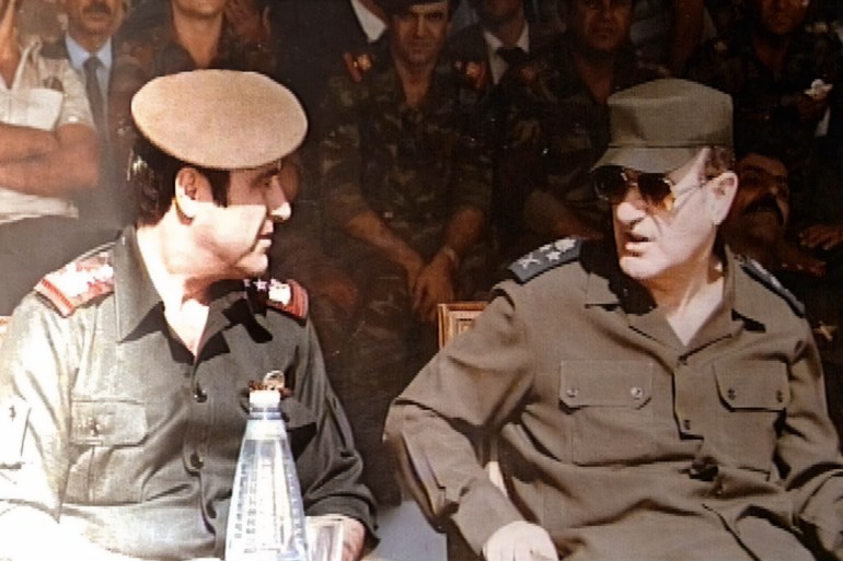 Picture taken in 1984 shows late Syrian president Hafez al-Assad (R) with his youngest brother Rifaat (L) at a military ceremony in Damascus. The estranged and banished brother, Rifaat, announced 12 June 2000 that he considers himself the legitimate successor to the presidency of Syria. The statement represents a direct challenge to the right of Bashar al-Assad, the late president's son and designated heir, to take the post. (Photo by Handout / AFP) / XGTY / == RESTRICTED TO EDITORIAL USE - MANDATORY CREDIT "AFP PHOTO / HO " - NO MARKETING NO ADVERTISING CAMPAIGNS - DISTRIBUTED AS A SERVICE TO CLIENTS == - XGTY / == RESTRICTED TO EDITORIAL USE - MANDATORY CREDIT "AFP PHOTO / HO " - NO MARKETING NO ADVERTISING CAMPAIGNS - DISTRIBUTED AS A SERVICE TO CLIENTS == / BEST QUALITY AVAILABLE