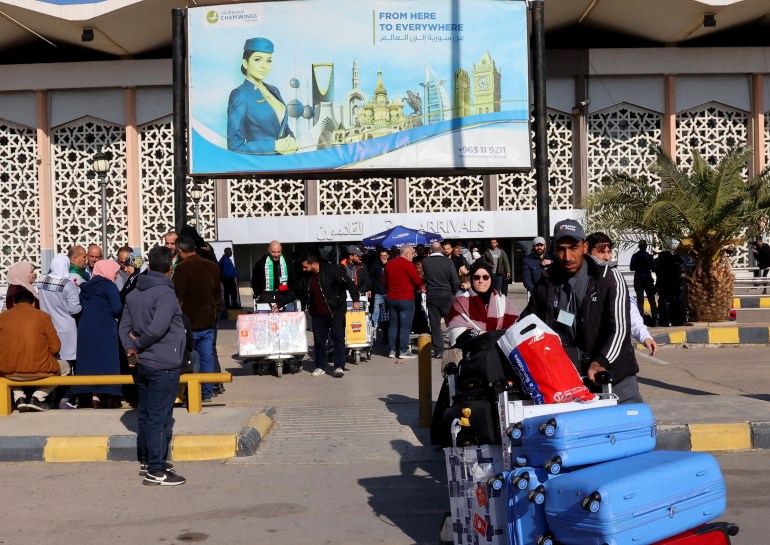 Passengers leave Damascus airport, as Qatar Airways becomes the first international airline to announce the return of international flights at Damascus airport after 13 years of its suspension, in Damascus, Syria, January 7, 2025. REUTERS/Yamam Al Shaar