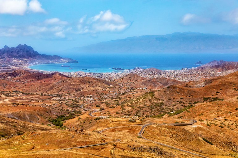 Bay and town of Mindelo, Island Sao Vicente, Cape Verde, Cabo Verde, Africa. Panoramic view of Mindelo seen from Monte Verde. Island Santo Antao in the background.