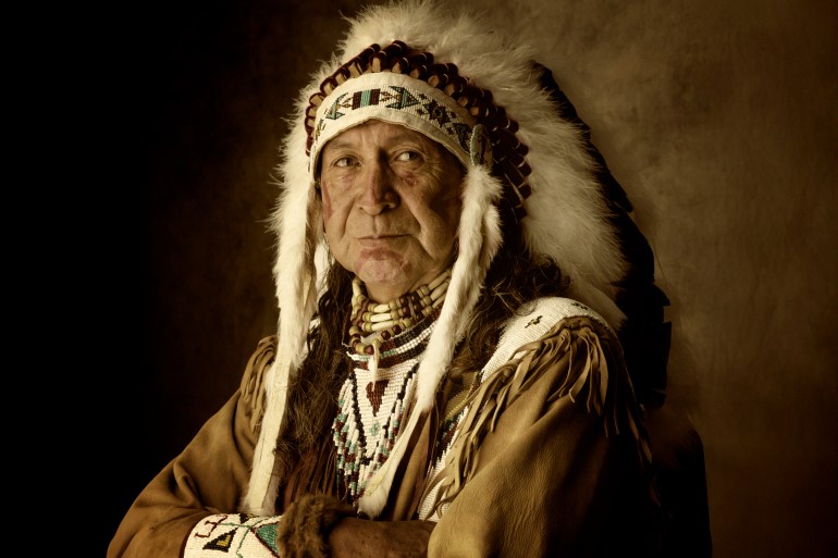 Native American man in traditional dress from the Siletz Tribe of Oregon.