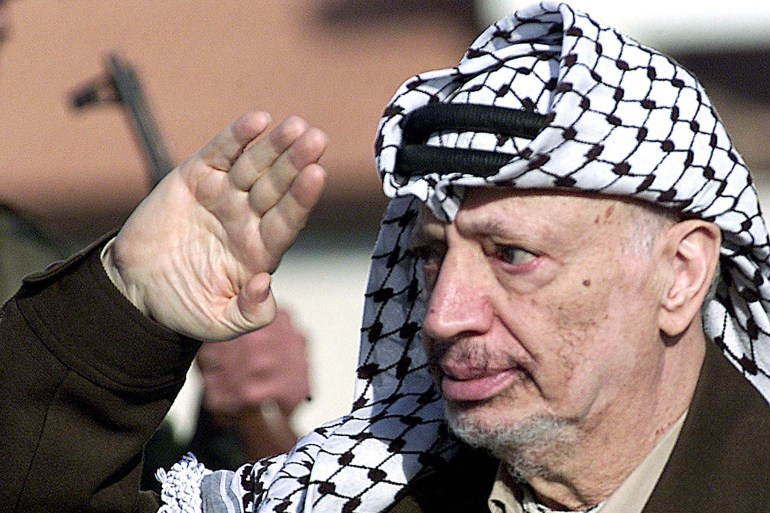 Palestinian President Yasser Arafat reviews the honour guards during his arrival in the the West Bank City of Ramallah November 12, 2001. Palestinian President Yasser Arafat has welcomed U.S. support for a two-state solution to the Middle East conflict, while accusing Israel of practicing state terror against a 13-month Palestinian uprising. REUTERS/Osama Silwadi OS/SJS REPORT CONTENT