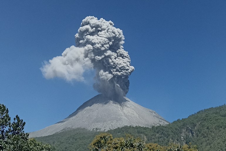 Mount Lewotobi Laki-laki spews volcanic ash during an eruption as seen from Boru village in East Flores, East Nusa Tenggara, on July 14, 2024. (Photo by Arnold Welianto / AFP)