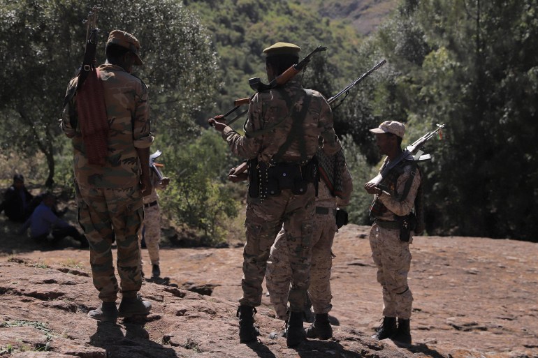 Members of the Amhara Special Forces stand guard next to the Saint George rock-hewn church in the Lalibela town of the Amhara Region, Ethiopia, January 25, 2022. Picture taken January 25, 2022. REUTERS/Tiksa Negeri