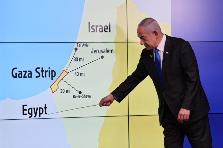 Israeli Prime Minister Benjamin Netanyahu stands before a map showing the Gaza Strip, during a press conference for the international media at the Government Press office in Jerusalem, amid the Israel-Hamas conflict, 04 September 2024. ABIR SULTAN/Pool via REUTERS