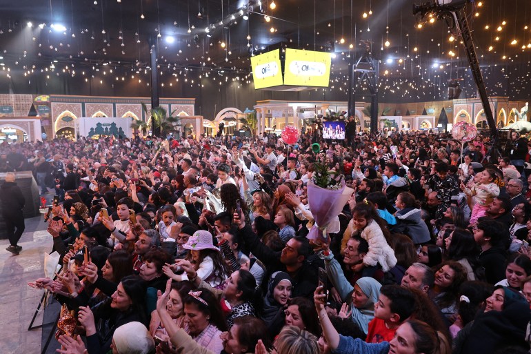 The audience cheers during the taping of the ìAkram Men Minî program, which airs on the LBCI channel during the Muslim holy fasting month of Ramadan, in Beirut on March 21, 2025. (Photo by ANWAR AMRO / AFP)