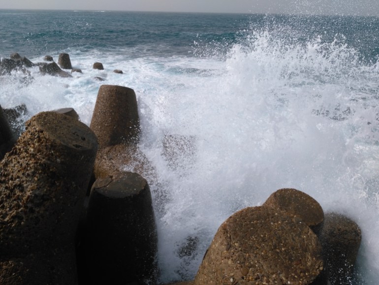 high sea waves hitting stone in winter