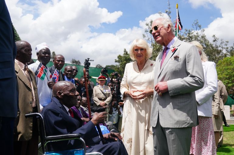 NAIROBI, KENYA - NOVEMBER 1: King Charles III and Queen Camilla meet veteran Samwel Nthigai Mburia, who is believed to be 117 years old, during a visit to the Commonwealth War Graves Commission cemetery in Nairobi, joining British and Kenyan military personnel in an act of remembrance, on day two of the state visit to Kenya on November 1, 2023 in Nairobi, Kenya. King Charles III and Queen Camilla are visiting Kenya for four days at the invitation of Kenyan President William Ruto, to celebrate the relationship between the two countries. The visit comes as Kenya prepares to commemorate 60 years of independence. (Photo by Pool - Victoria Jones/Getty Images)