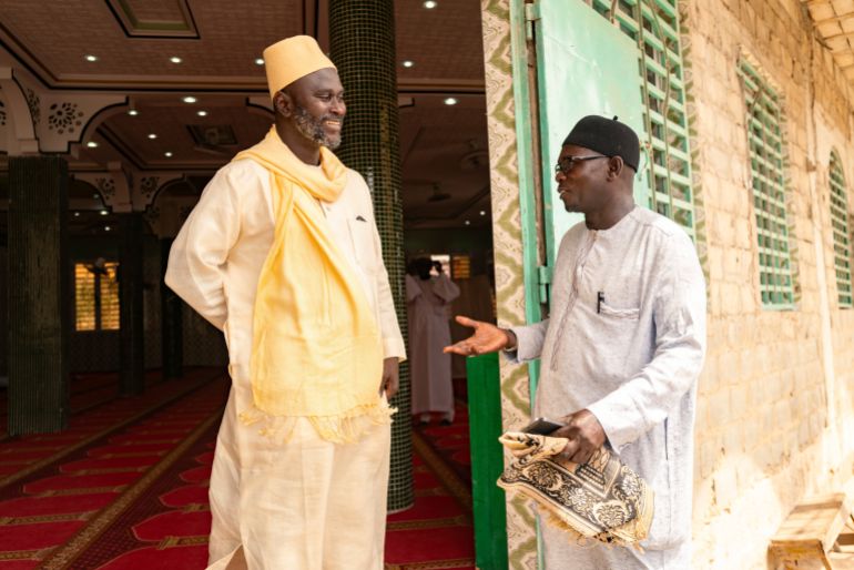 Imam Ibrahima Diane, left, advocate for an end to gender-based violence and practices like female genital mutilation, discusses with El Hadj Malick, coordinator of the "École des Maris" program at the Great Mosque of Nietty Mbar in Thiaroye, a suburb of Dakar, Senegal, Friday, July 4, 2025.(AP Photo/Sylvain Cherkaoui)